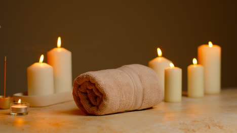 Still-Life-Of-Lit-Candles-And-Incense-Stick-With-Soft-Towels-As-Part-Of-Relaxing-Spa-Day-Decor